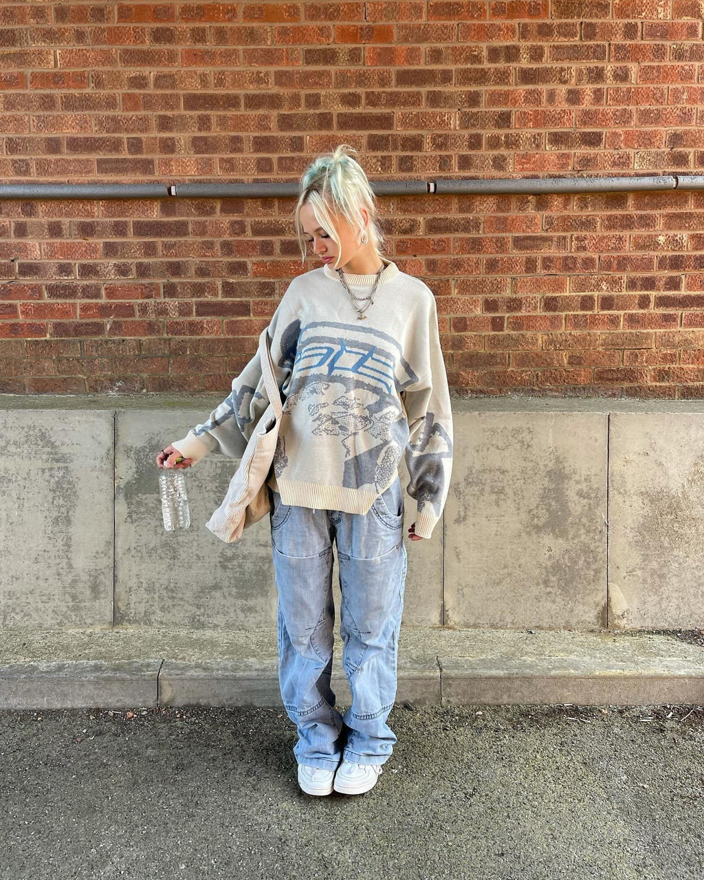 Light-colored streetwear sweater with large front graphic print and long sleeves