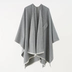 Light gray cashmere poncho with V-neck, draped sleeves, fringe hem