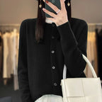 Women’s cardigan sweater, button-front knit, long sleeves, black knit with buttons.