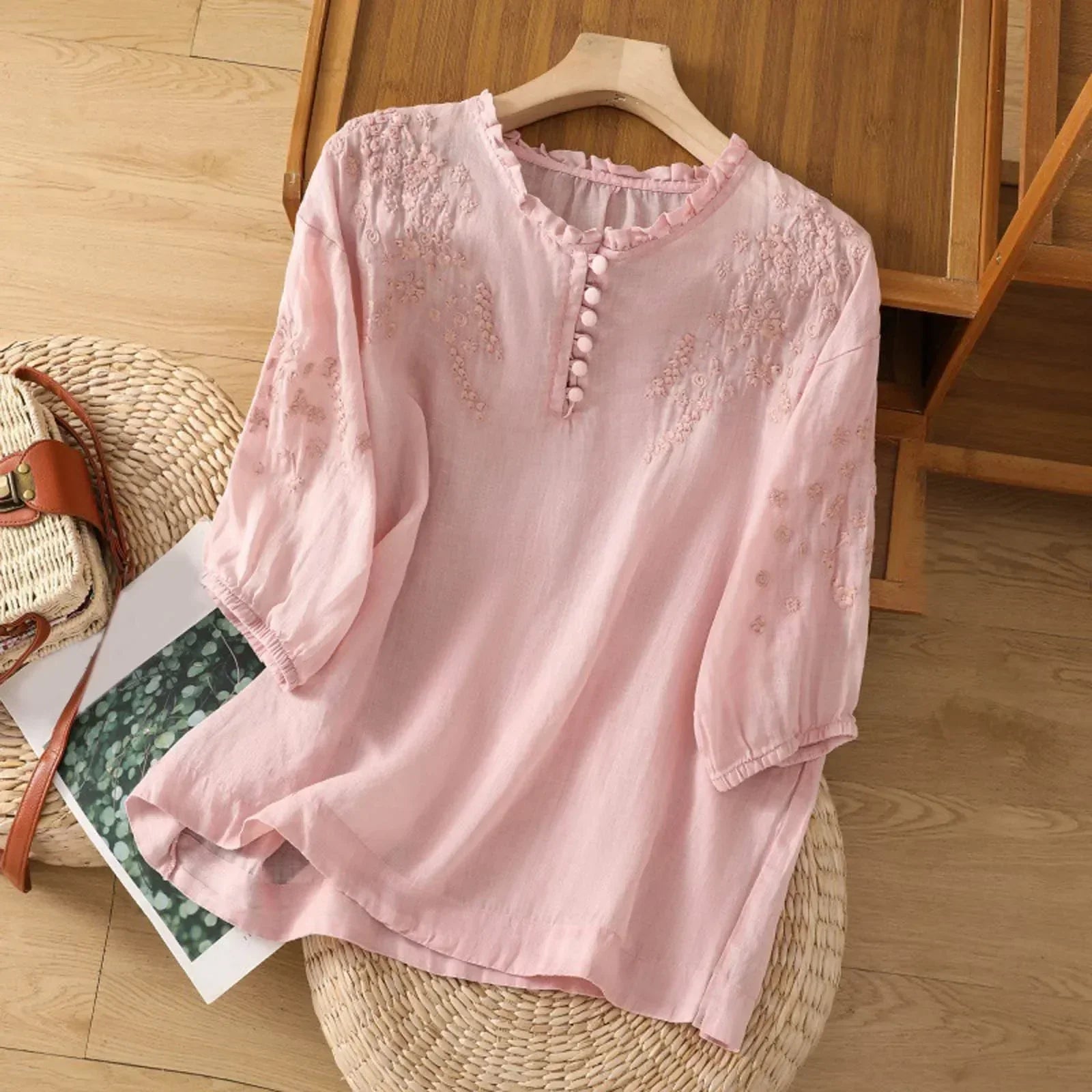 Pink embroidered relaxed blouse with half-button front and three-quarter sleeves