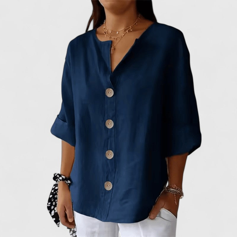 Navy blue V-neck button-front blouse with short cuffed sleeves and wooden buttons