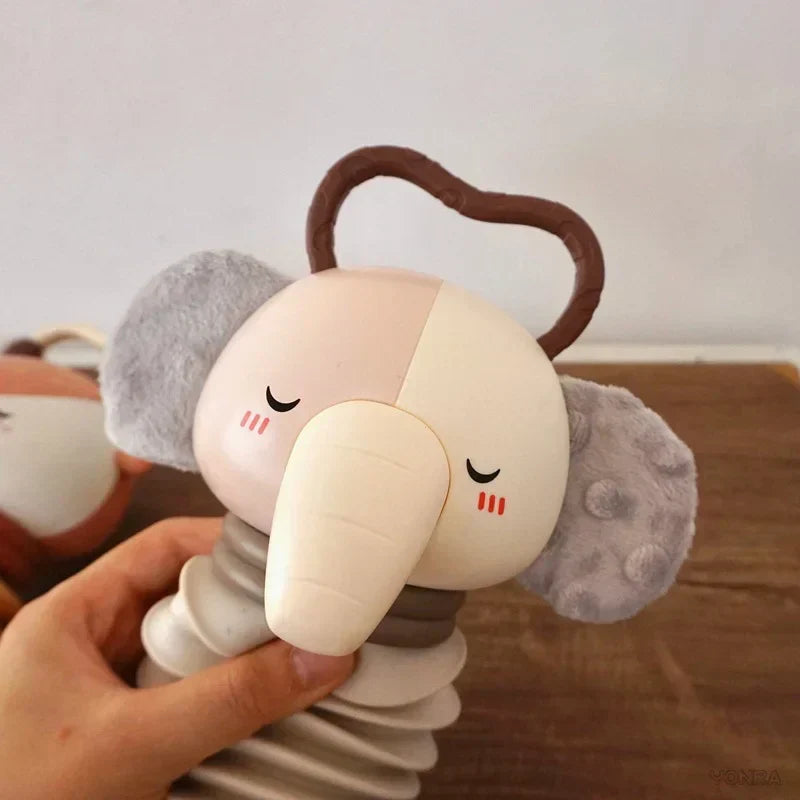 Grey and white plush animal accordion toy with curved handle and rattle coils
