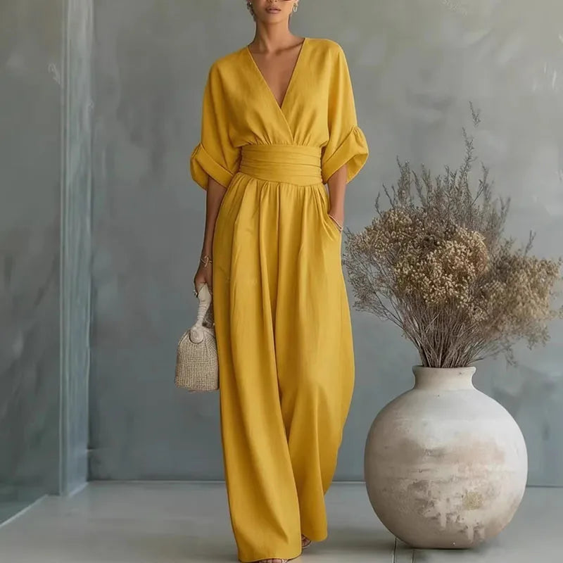 Yellow V-neck summer jumpsuit with short sleeves, cinched waist, and wide legs