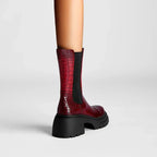 Dark red ankle boots with black elastic side panels and chunky platform lug sole