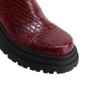 Dark red leather-look platform boot toe with black rubber lug sole