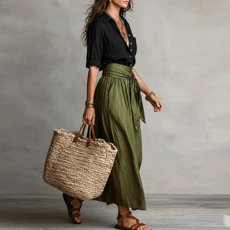 Linen co-ord set with black V-neck blouse and olive green tie-waist skirt