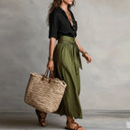 Linen co-ord set with black V-neck blouse and olive green tie-waist skirt