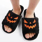 Women's black plush Halloween jack-o-lantern slide slippers with orange and black faces