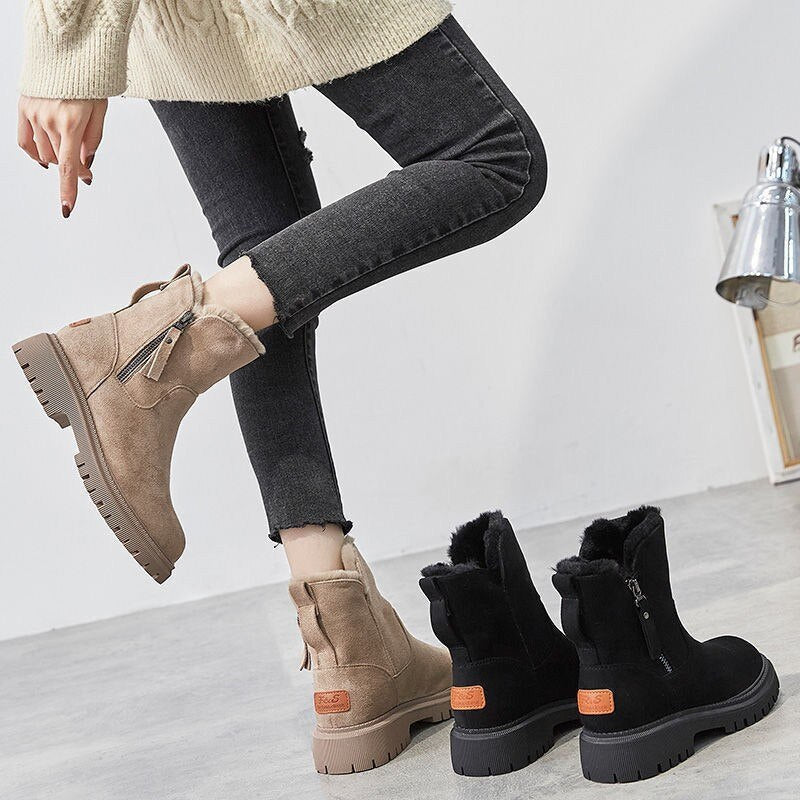 Women’s ankle boots in beige and black, each with side zipper and rugged tread soles