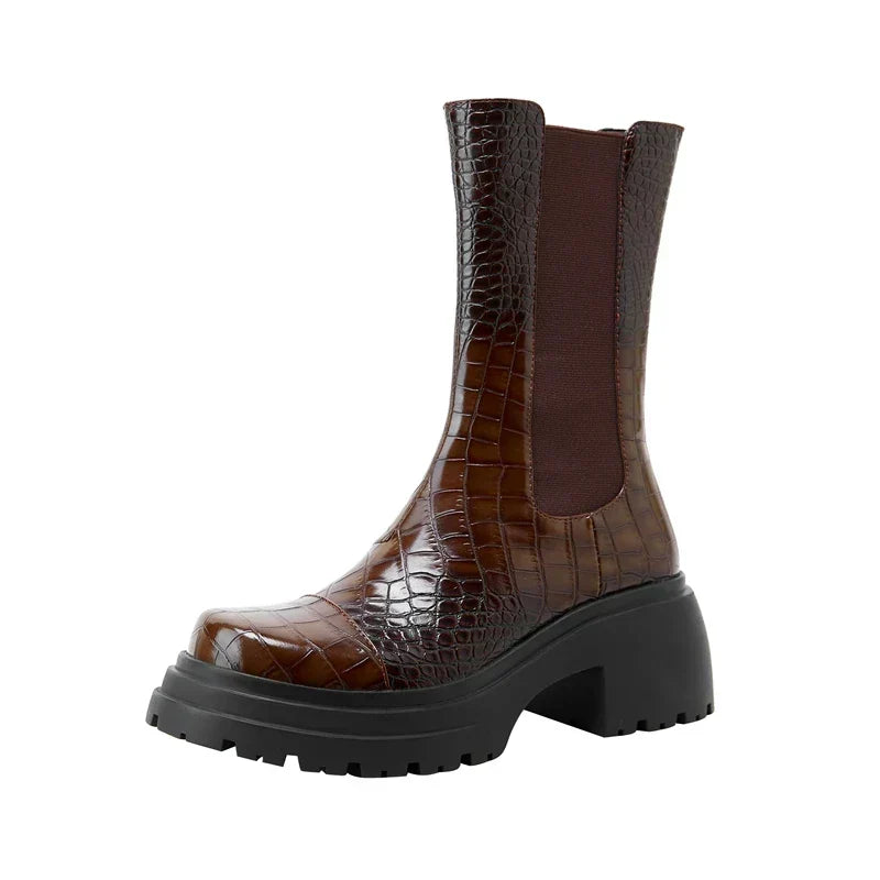Brown ankle boots with elastic side panels and chunky platform sole in a lug style