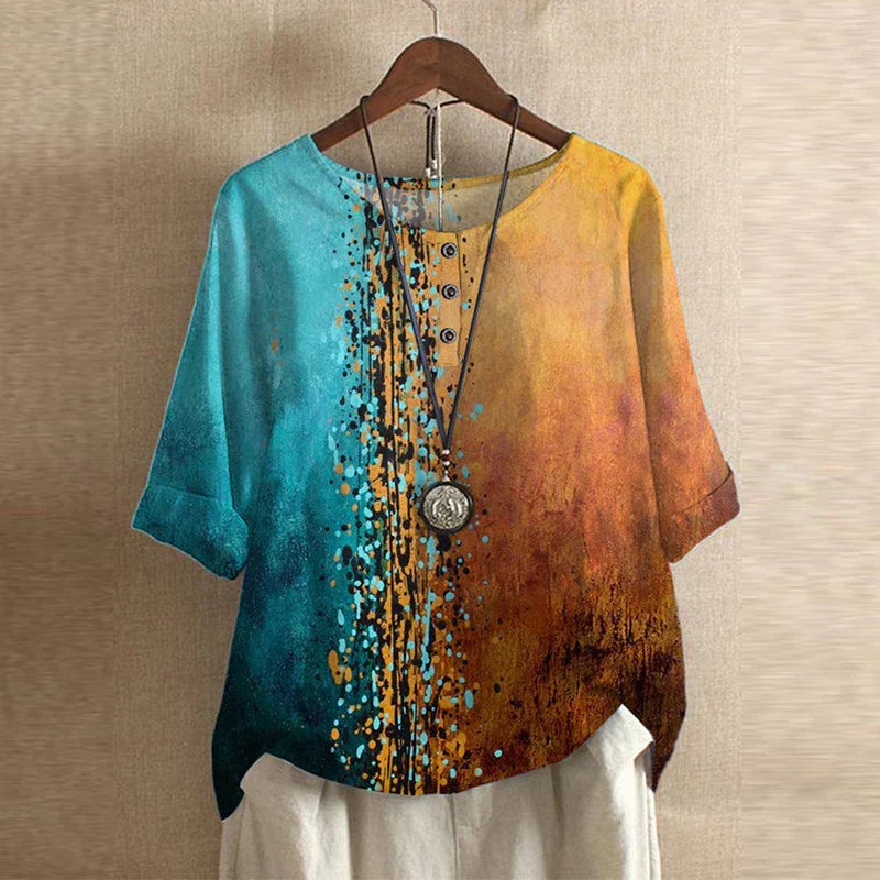 Women’s blouse with turquoise-to-yellow color block, speckled floral look, button front