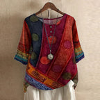 Women’s blouse in rust red with multicolor patch floral print, short sleeves, button front