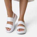 White two-strap platform sandals with adjustable buckle and cushioned sole