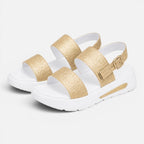 Pair of gold glitter platform sandals with wide straps and adjustable buckle