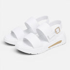 Pair of white platform sandals with wide cross straps and adjustable buckle