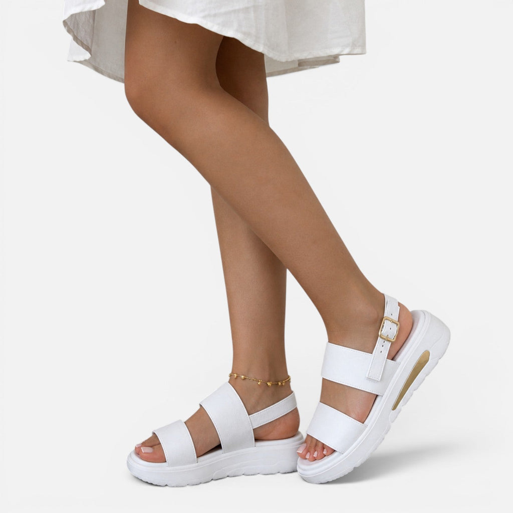 White platform sandals with adjustable ankle buckle straps and open toe