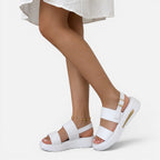 White platform sandals with adjustable ankle buckle straps and open toe