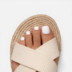 Beige cross-strap espadrille slide sandals with ribbed fabric upper and open toe