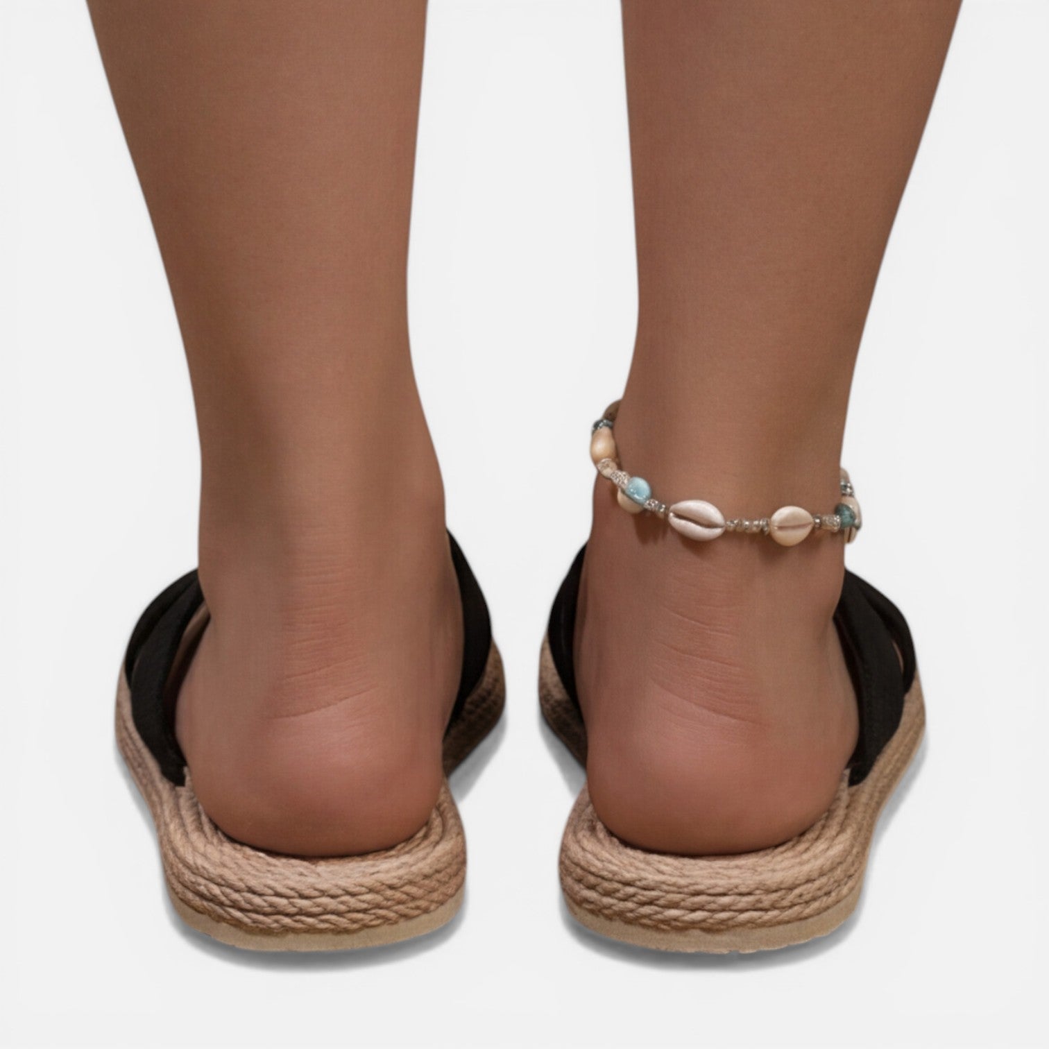 Women’s black cross-strap espadrille slide sandals with shell bead ankle bracelet