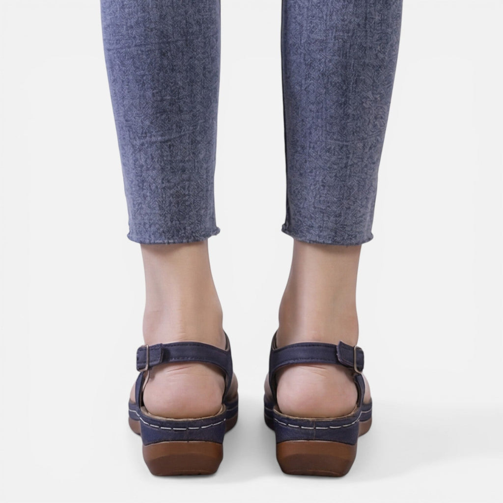Women’s navy wedge sandals, back view with adjustable buckle straps