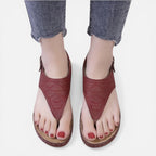 Women’s red wedge sandals, back view with adjustable buckle closure