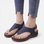 Women’s navy wedge sandals with cutout upper and brown bottom sole