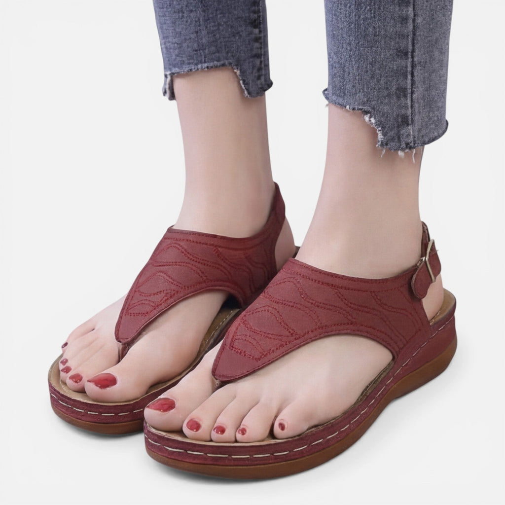 Women’s red wedge sandals with thong strap and buckled ankle strap