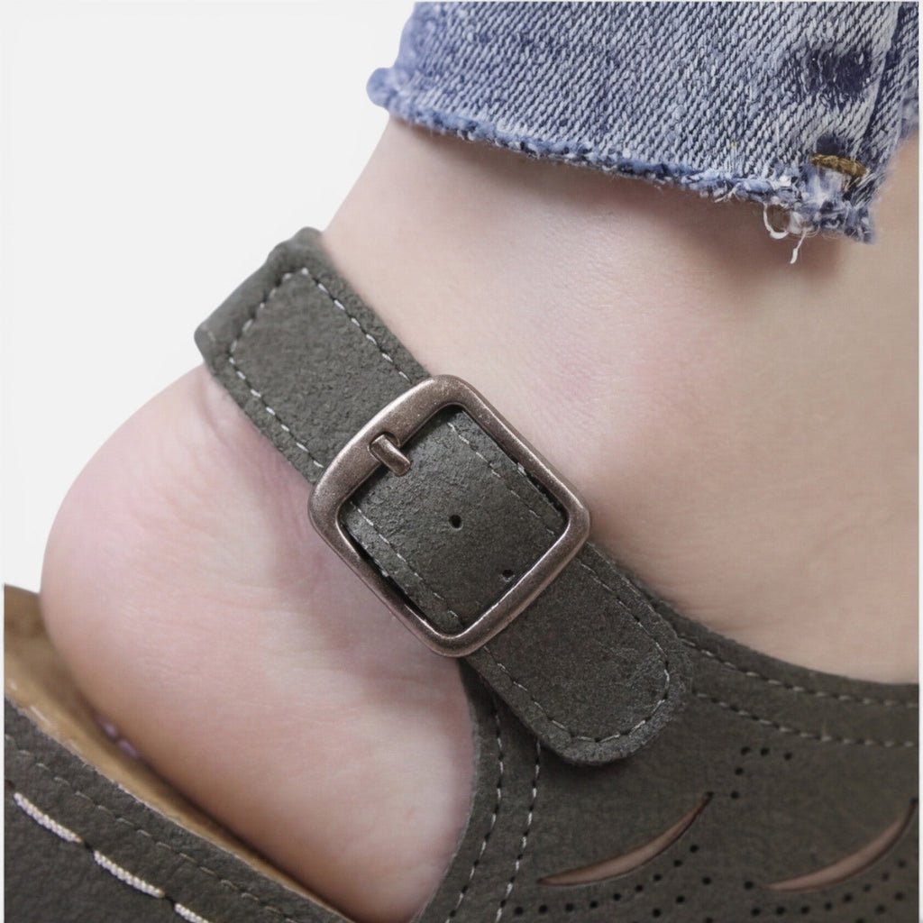 Close-up of women’s olive sandal buckle with stitched strap and cushioned footbed