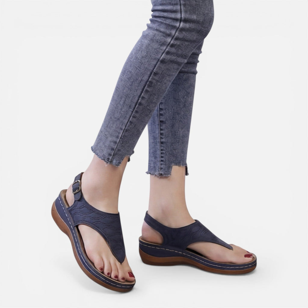 Women’s navy wedge sandals with thong strap and buckled ankle strap