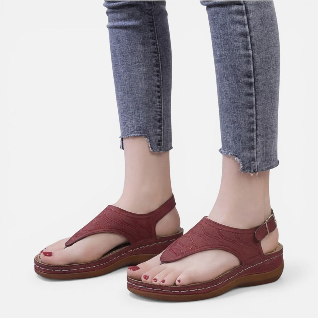 Women’s red wedge sandals with open-toe thong strap and metal buckle