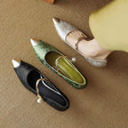 Pointed kitten heels in green, black and metallic tones, pearl strap with gold buckle