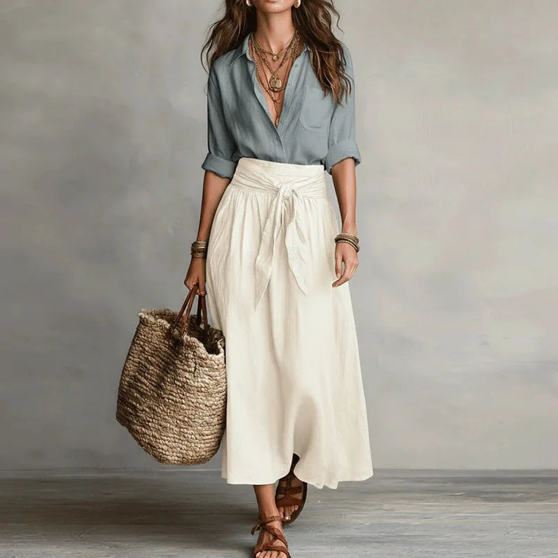 Linen co-ord set with light blue V-neck blouse and white tie-waist midi skirt