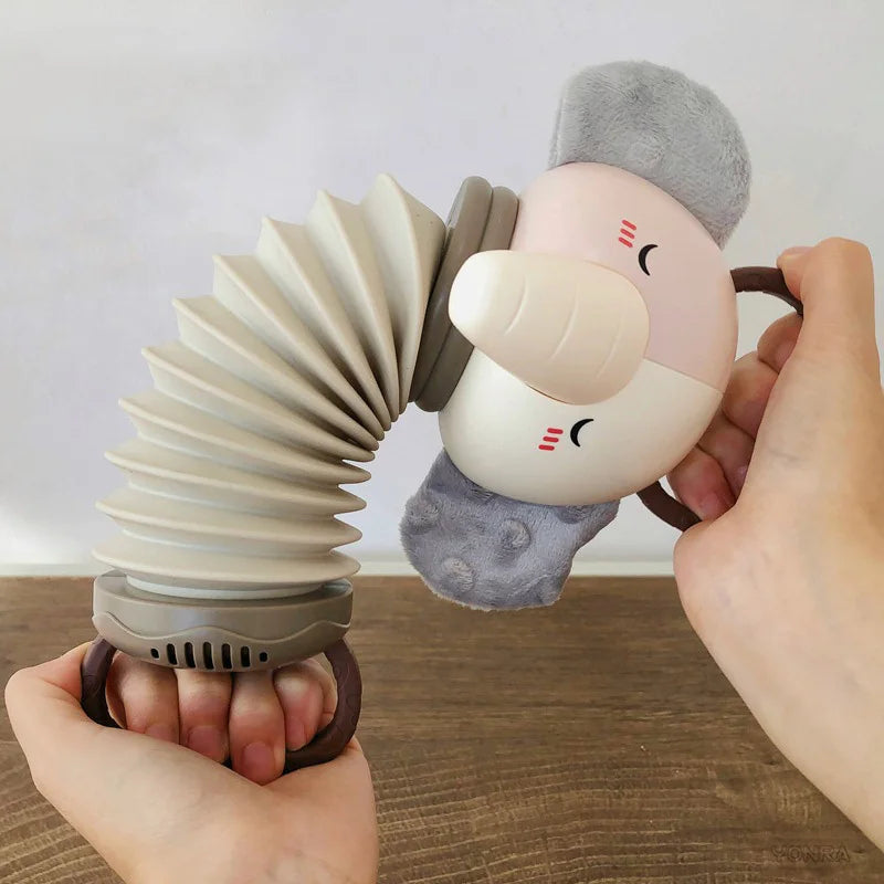 Animal accordion toy with cream face and grey plush ears held beside stacked coils