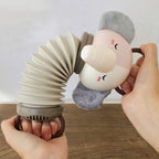 Animal accordion toy with cream face and grey plush ears held beside stacked coils