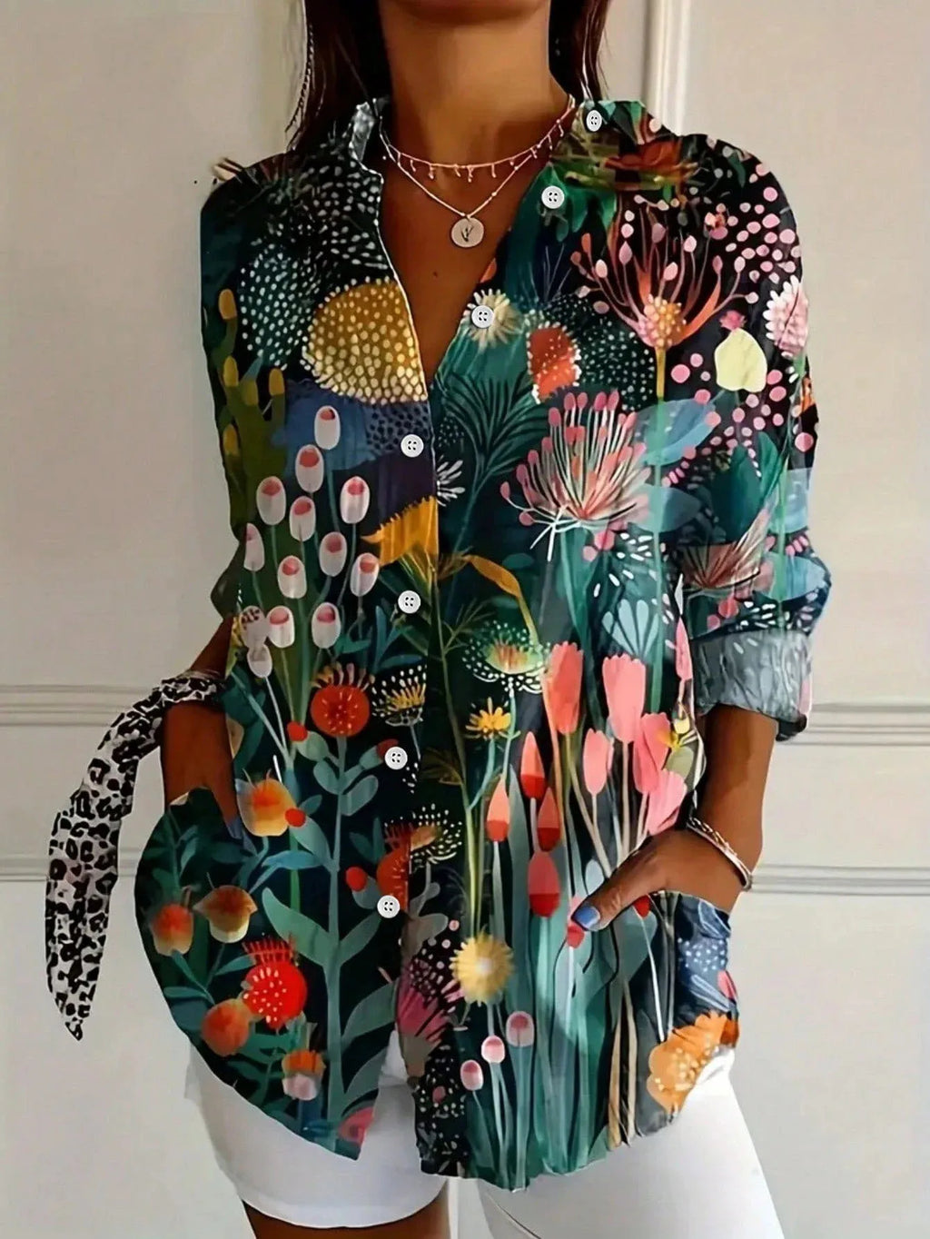 Women's abstract print blouse with button front, dark floral garden print, long sleeves.