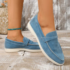 Blue suede slip-on loafers with moc-toe stitching and white rubber sole