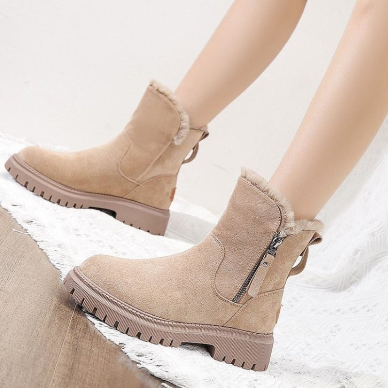Beige women’s ankle boots with round toe, side zipper, and thick lug tread sole