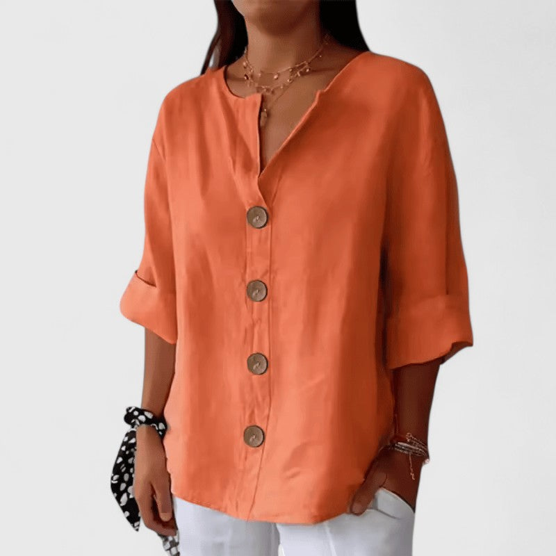 Orange V-neck button-front blouse with short cuffed sleeves and round wooden buttons