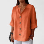 Orange V-neck button-front blouse with short cuffed sleeves and round wooden buttons