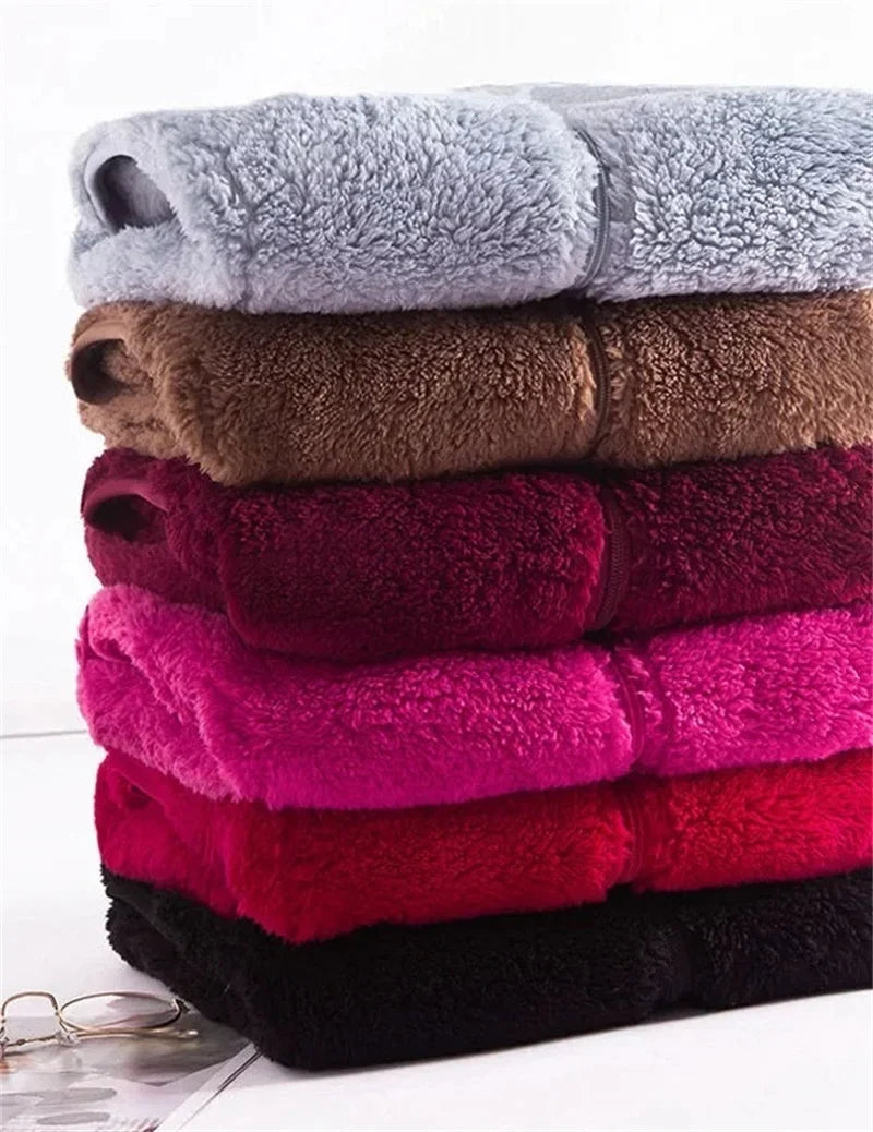 Stacked sherpa sleeveless bodywarmers in pale blue, brown, burgundy, and dark colors