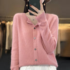 Women’s cardigan sweater, button-front knit, long sleeves, pink knit with buttons.