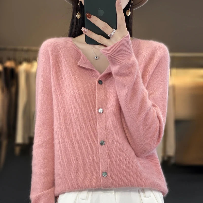 Women’s cardigan sweater, button-front knit, long sleeves, pink knit with buttons.