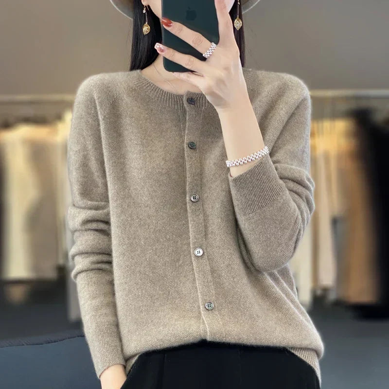 Women’s cardigan sweater, button-front knit, long sleeves, light brown knit with buttons.