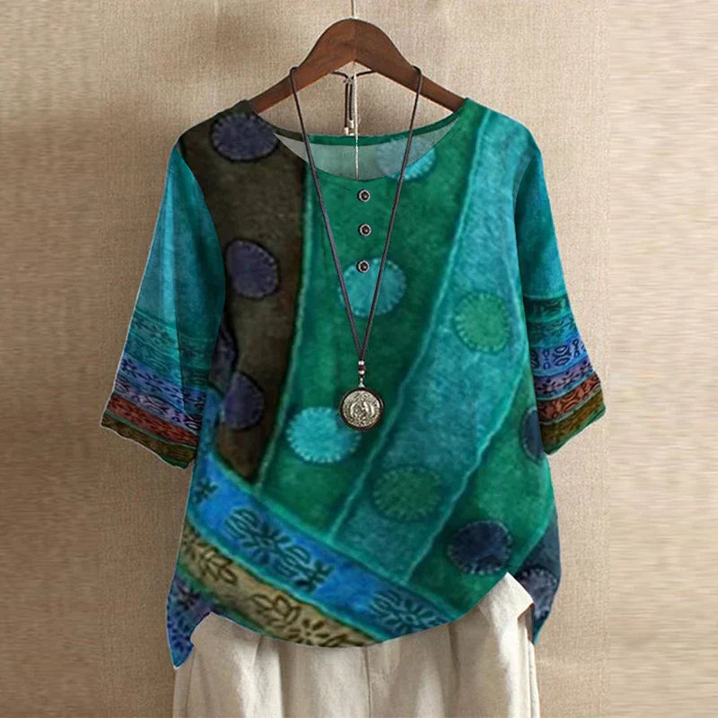Women’s blouse in teal and blue with circular print, short sleeves, button front