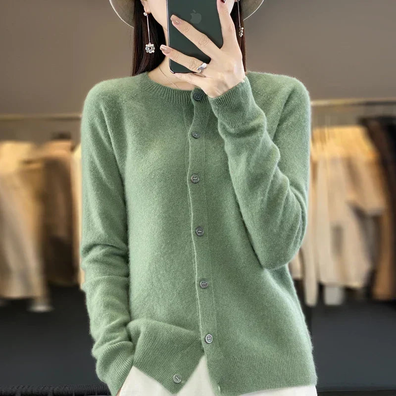 Women’s cardigan sweater, button-front knit, long sleeves, green knit with buttons.