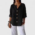Black V-neck button-front blouse with short sleeves and round wooden buttons