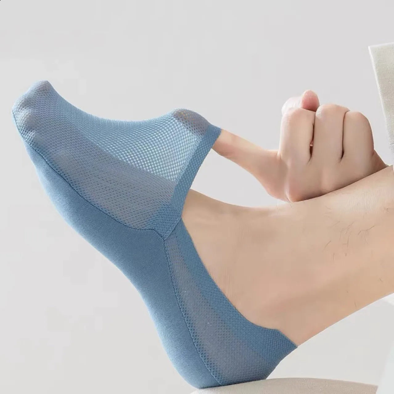Blue no-show socks on foot, stretchy sheer knit