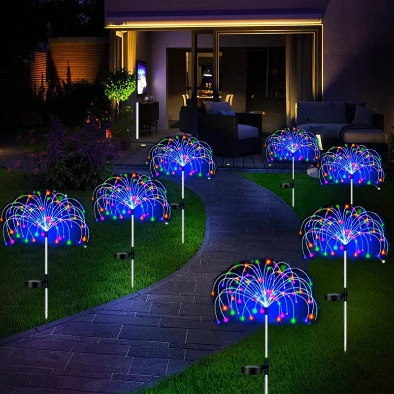 Solar pathway stake LED lights with multicolor glow, round fan heads on garden stems.