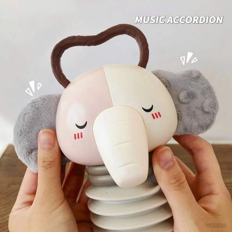 Grey and white plush animal accordion toy with padded ears and smiling face