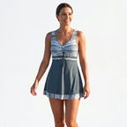 Dark blue tankini set with blue patterned bodice, V-neck tie front and short skirt